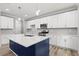 Modern kitchen featuring white cabinets, stainless steel appliances, and quartz countertops at 5341 Stewart Mill Rd, Douglasville, GA 30135
