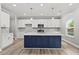 Modern kitchen featuring white cabinets, a dark blue island, and stainless steel appliances at 5341 Stewart Mill Rd, Douglasville, GA 30135