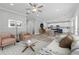 Open-concept living room with sleek furnishings, flowing into the kitchen and dining area with modern finishes at 5341 Stewart Mill Rd, Douglasville, GA 30135