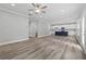 Open-concept living space with modern flooring, gray walls, and a view of the kitchen at 5341 Stewart Mill Rd, Douglasville, GA 30135
