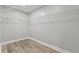 Spacious walk-in closet with wire shelving and wood-look flooring at 5341 Stewart Mill Rd, Douglasville, GA 30135