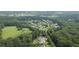 Expansive aerial view showcasing a beautiful home nestled among lush trees in a serene neighborhood setting at 104 Trinity Hollow Dr, Canton, GA 30115
