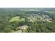 Expansive aerial view showcasing a beautiful home nestled among lush trees in a serene neighborhood setting at 104 Trinity Hollow Dr, Canton, GA 30115