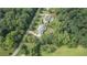 Aerial perspective captures a home surrounded by mature trees and lush greenery at 104 Trinity Hollow Dr, Canton, GA 30115