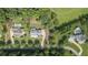 An aerial view of a home surrounded by lush landscaping and neighboring properties with pools at 104 Trinity Hollow Dr, Canton, GA 30115