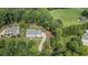 Aerial view of a house with a long driveway, surrounded by lush greenery and neighboring properties at 104 Trinity Hollow Dr, Canton, GA 30115