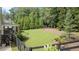 Expansive backyard with mature trees, lush lawn, and a cozy outdoor fireplace area at 104 Trinity Hollow Dr, Canton, GA 30115