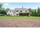 Expansive backyard with lush green grass, leading up to a charming white farmhouse style home at 104 Trinity Hollow Dr, Canton, GA 30115