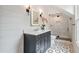 Stylish bathroom features a modern vanity, chic lighting, a glass-enclosed shower, and unique patterned tile flooring at 104 Trinity Hollow Dr, Canton, GA 30115