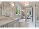 Well-lit bathroom featuring a soaking tub, walk-in shower, dual vanities and doorway to another room at 104 Trinity Hollow Dr, Canton, GA 30115