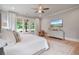 Bright bedroom features hardwood floors, large windows, and ceiling fan at 104 Trinity Hollow Dr, Canton, GA 30115