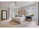 Spacious bedroom with hardwood floors, ceiling fan, and abundant natural light at 104 Trinity Hollow Dr, Canton, GA 30115