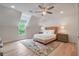 Charming bedroom featuring a decorative chandelier, plush rug, and a cozy bed with natural light streaming through the window at 104 Trinity Hollow Dr, Canton, GA 30115