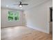 Minimalist bedroom with hardwood floors and a large window offering views of the lush greenery outside at 104 Trinity Hollow Dr, Canton, GA 30115