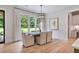 Bright dining room features an elegant light fixture, large windows and hardwood floors at 104 Trinity Hollow Dr, Canton, GA 30115
