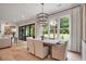 Dining room with modern chandelier open to backyard and living room at 104 Trinity Hollow Dr, Canton, GA 30115