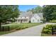 Stately home with a manicured lawn, mature trees, and long driveway at 104 Trinity Hollow Dr, Canton, GA 30115