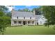Beautiful home with a welcoming front porch, two chimneys, and well-maintained landscaping at 104 Trinity Hollow Dr, Canton, GA 30115