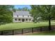 Charming home featuring a spacious front lawn, a well-manicured yard and a black fence at 104 Trinity Hollow Dr, Canton, GA 30115
