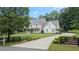 Charming home featuring a spacious front lawn, a well-manicured yard and a black fence at 104 Trinity Hollow Dr, Canton, GA 30115