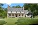 Charming two-story home with a spacious front yard, covered porch, and brick chimneys at 104 Trinity Hollow Dr, Canton, GA 30115