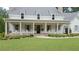Inviting front porch with classic white rocking chairs, a brick foundation and beautiful landscaping at 104 Trinity Hollow Dr, Canton, GA 30115