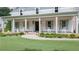 Inviting front porch with rocking chairs, brick accents, and manicured landscaping at 104 Trinity Hollow Dr, Canton, GA 30115