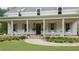 Inviting front porch with classic white rocking chairs, a brick foundation and beautiful landscaping at 104 Trinity Hollow Dr, Canton, GA 30115
