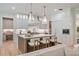 Well-lit kitchen with stainless steel appliances, a central island with bar stools, and ample cabinet space at 104 Trinity Hollow Dr, Canton, GA 30115