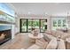 Bright living room featuring a fireplace, large screen tv, and access to the covered outdoor dining area at 104 Trinity Hollow Dr, Canton, GA 30115