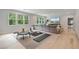 Bright and airy living room with large windows, offering ample natural light and space for relaxation at 104 Trinity Hollow Dr, Canton, GA 30115