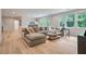 Bright living room with a comfortable sectional sofa and hardwood flooring, perfect for relaxation and entertaining at 104 Trinity Hollow Dr, Canton, GA 30115