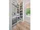 Bright pantry featuring custom white shelving, wine cooler, and beverage station at 104 Trinity Hollow Dr, Canton, GA 30115