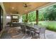 Covered outdoor patio with a dining area, stone floors, and a fireplace at 104 Trinity Hollow Dr, Canton, GA 30115