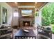 Cozy outdoor fireplace and seating area on the covered patio at 104 Trinity Hollow Dr, Canton, GA 30115