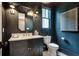 Stylish powder room with black walls, framed mirror, sconces and marble countertop at 104 Trinity Hollow Dr, Canton, GA 30115