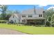 Rear exterior of a home featuring a covered patio, well-manicured landscaping, and a spacious yard at 104 Trinity Hollow Dr, Canton, GA 30115
