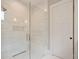 Luxurious walk-in shower with glass enclosure, tiled walls, a built-in bench, and modern fixtures at 104 Trinity Hollow Dr, Canton, GA 30115
