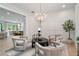 Relaxing sitting area showcasing hardwood floors, decorative lighting, and seamless flow to other rooms at 104 Trinity Hollow Dr, Canton, GA 30115