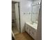 Bathroom featuring a white sink, mirror and patterned wallpaper throughout at 512 Rockborough Ter, Stone Mountain, GA 30083