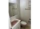A pink bathroom featuring a toilet, sink, vanity and wallpaper at 512 Rockborough Ter, Stone Mountain, GA 30083
