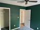 Bedroom with green walls, white trim and ceiling fan; offering comfortable living space at 512 Rockborough Ter, Stone Mountain, GA 30083