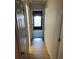 An interior hallway with multiple doorways and light-colored hardwood floors at 512 Rockborough Ter, Stone Mountain, GA 30083