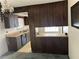 View of the kitchen showcasing wood cabinets, laminate countertops and a breakfast bar at 512 Rockborough Ter, Stone Mountain, GA 30083