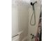 A simple shower stall with a handheld shower head and floral shower curtain at 512 Rockborough Ter, Stone Mountain, GA 30083