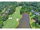 Beautiful aerial view of a golf course community featuring a lush green landscape and a serene lake at 829 Big Horn Holw, Suwanee, GA 30024