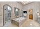 Luxurious bathroom featuring a soaking tub, walk-in shower, dual vanities, and tiled walls for an elegant design at 829 Big Horn Holw, Suwanee, GA 30024