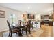 Dining area with stylish table, chairs, and an adjacent kitchen with stainless steel appliances at 1363 Midnight Ride Ct, Hampton, GA 30228