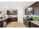 Kitchen with granite counters, stainless steel appliances and dark cabinets at 1363 Midnight Ride Ct, Hampton, GA 30228