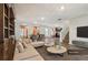 Open-concept living room and dining area with modern furnishings and ample natural light at 1363 Midnight Ride Ct, Hampton, GA 30228